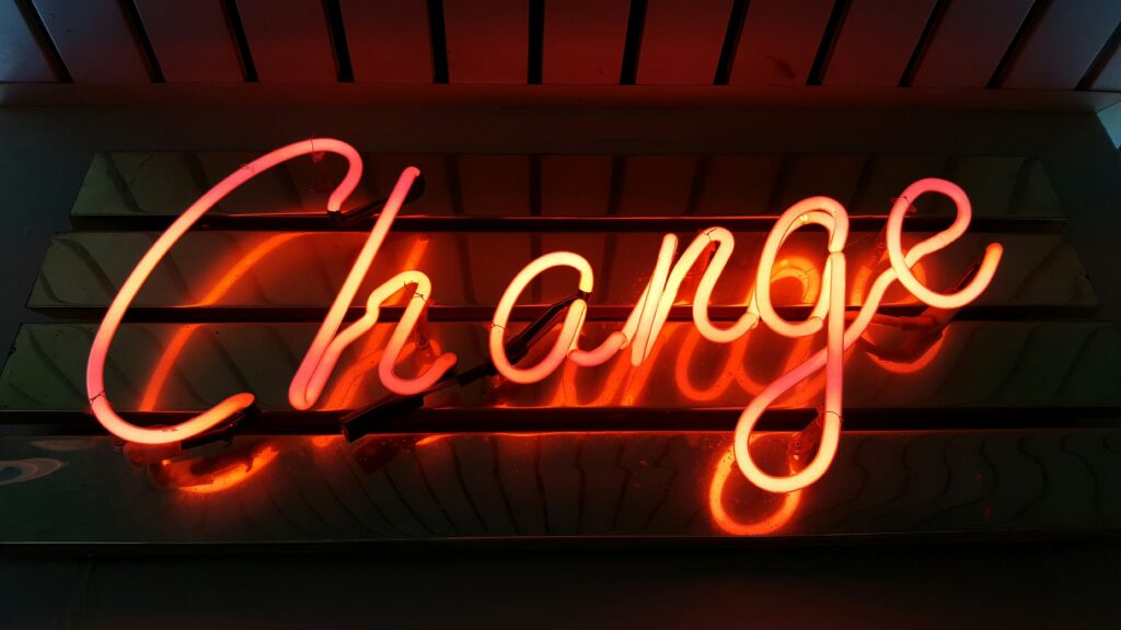 Neon sign glowing with the word 'change' in bright colors, symbolizing new beginnings and positive transformations.